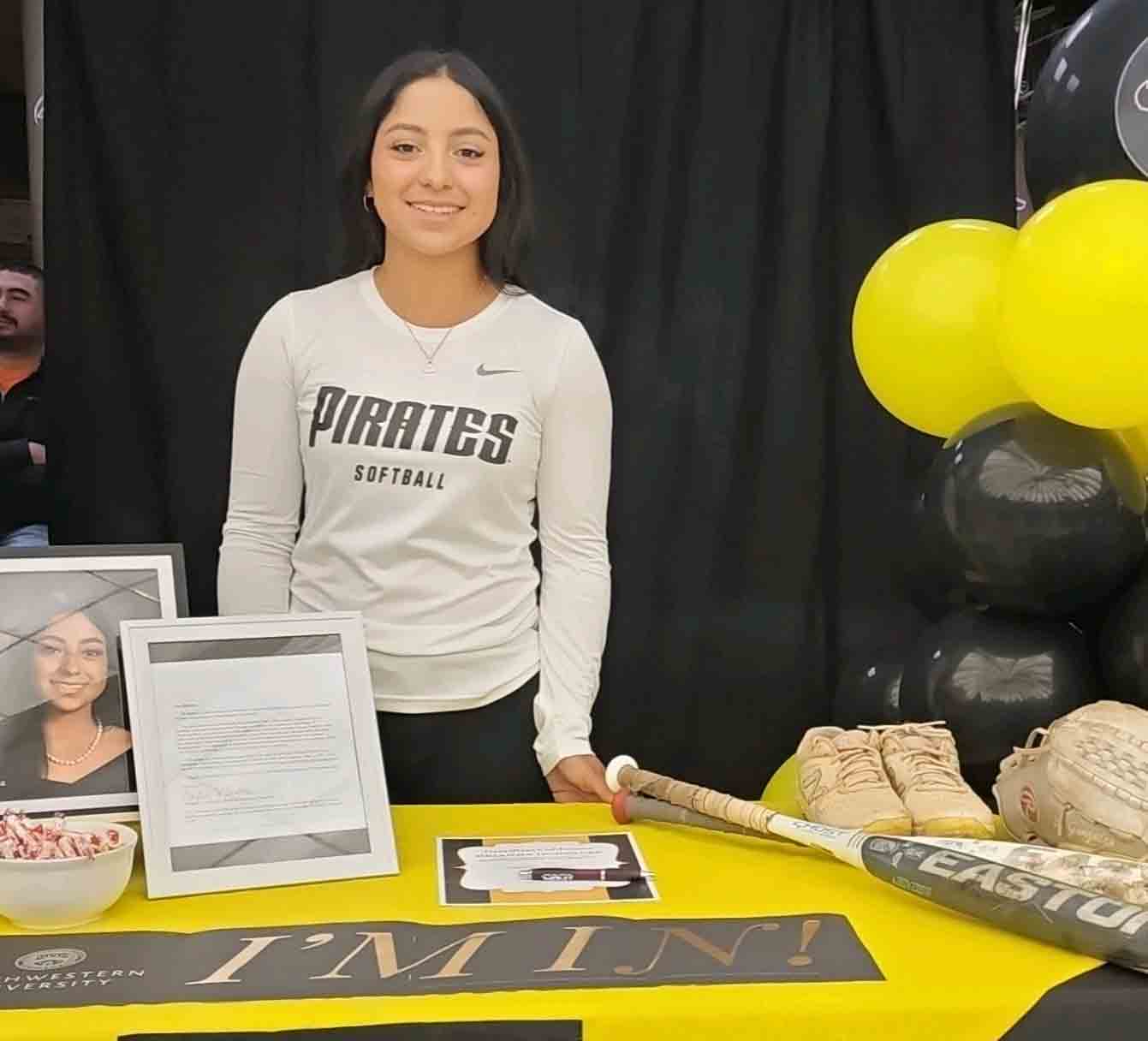 Brianna Gonzales stands behind a table at a graduation party