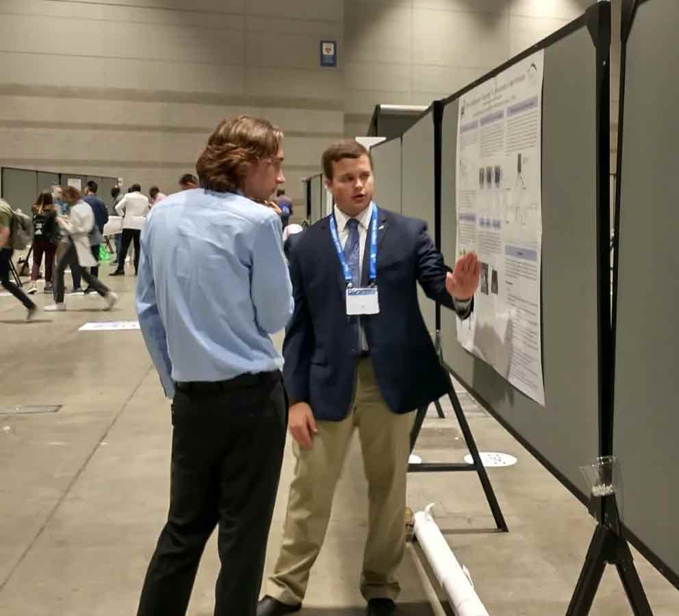 Christian Bell presents information to a fellow student
